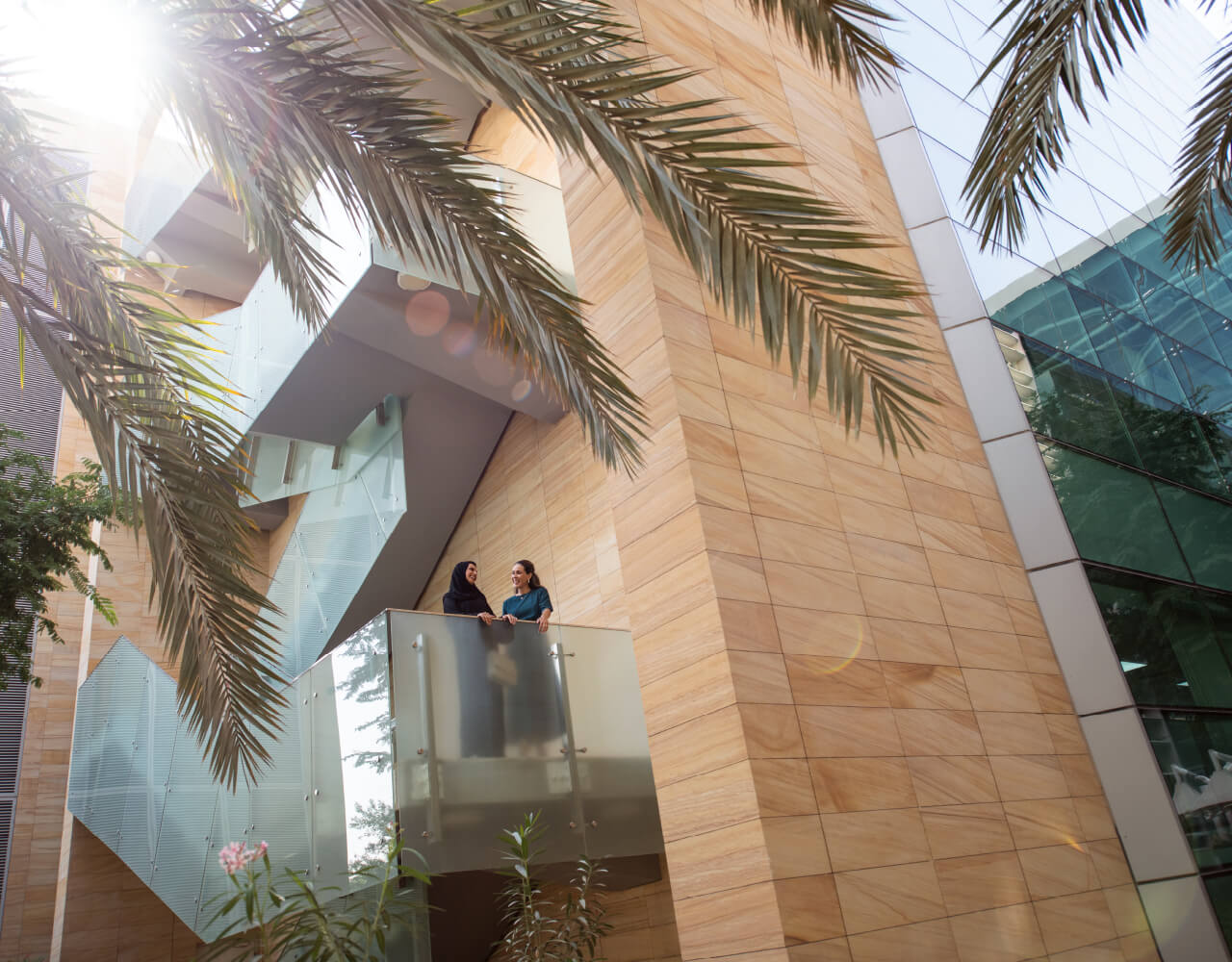 Two women standing in the balcony at Dubai Science Park's premises